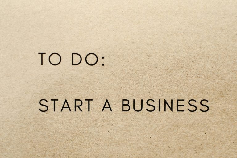 What Do You Need To Consider Before Going Into Business? Text on a brown paper background reads: "TO DO: START A BUSINESS.