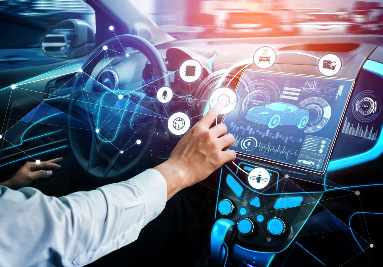 Advanced Ford Infotainment Technologies Compared A person interacts with a futuristic car dashboard touchscreen displaying vehicle data and digital connectivity icons, highlighting advanced automotive technology.