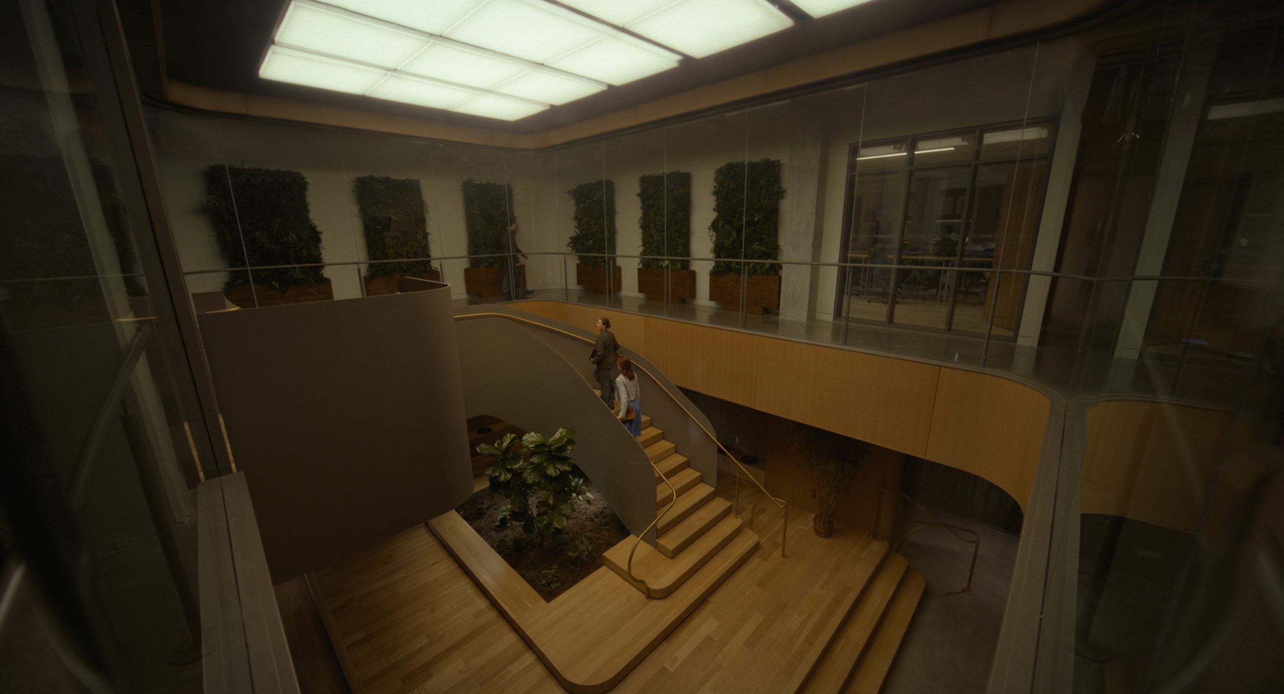 A modern interior with wooden stairs, glass railings, potted plants, and two people walking down the staircase under a large illuminated ceiling panel.