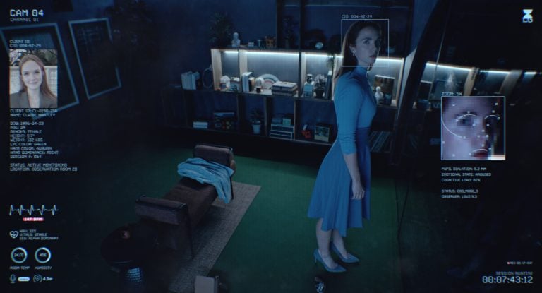 A woman in a blue dress stands in a dimly lit room, viewed by a surveillance camera interface displaying identification and facial recognition data.