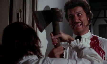 Severin Films Announces Summer Titles Including Terrifying Nuclear War Films, Surreal Genre Box Sets & More A man in a white shirt holds an axe while struggling with another person; his shirt is stained with blood and he appears distressed.