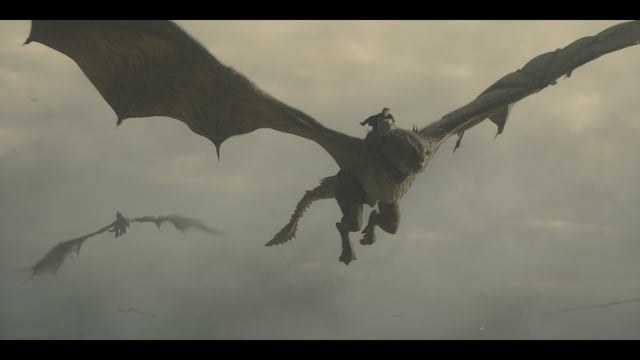 Two large dragons fly through a cloudy sky with riders on their backs, with one dragon and rider prominently in the foreground.