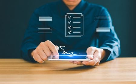 Why Contracts Get Stuck And How Electronic Signatures Help A person in a blue shirt uses a tablet to create a digital signature, with illustrated checklists and signature icons superimposed.