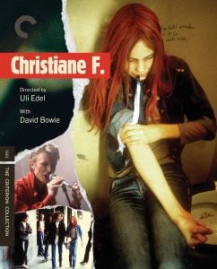 A young woman prepares to inject her arm while sitting; inset images show a man singing and a group walking. Text identifies the film as “Christiane F.” directed by Uli Edel, with David Bowie.