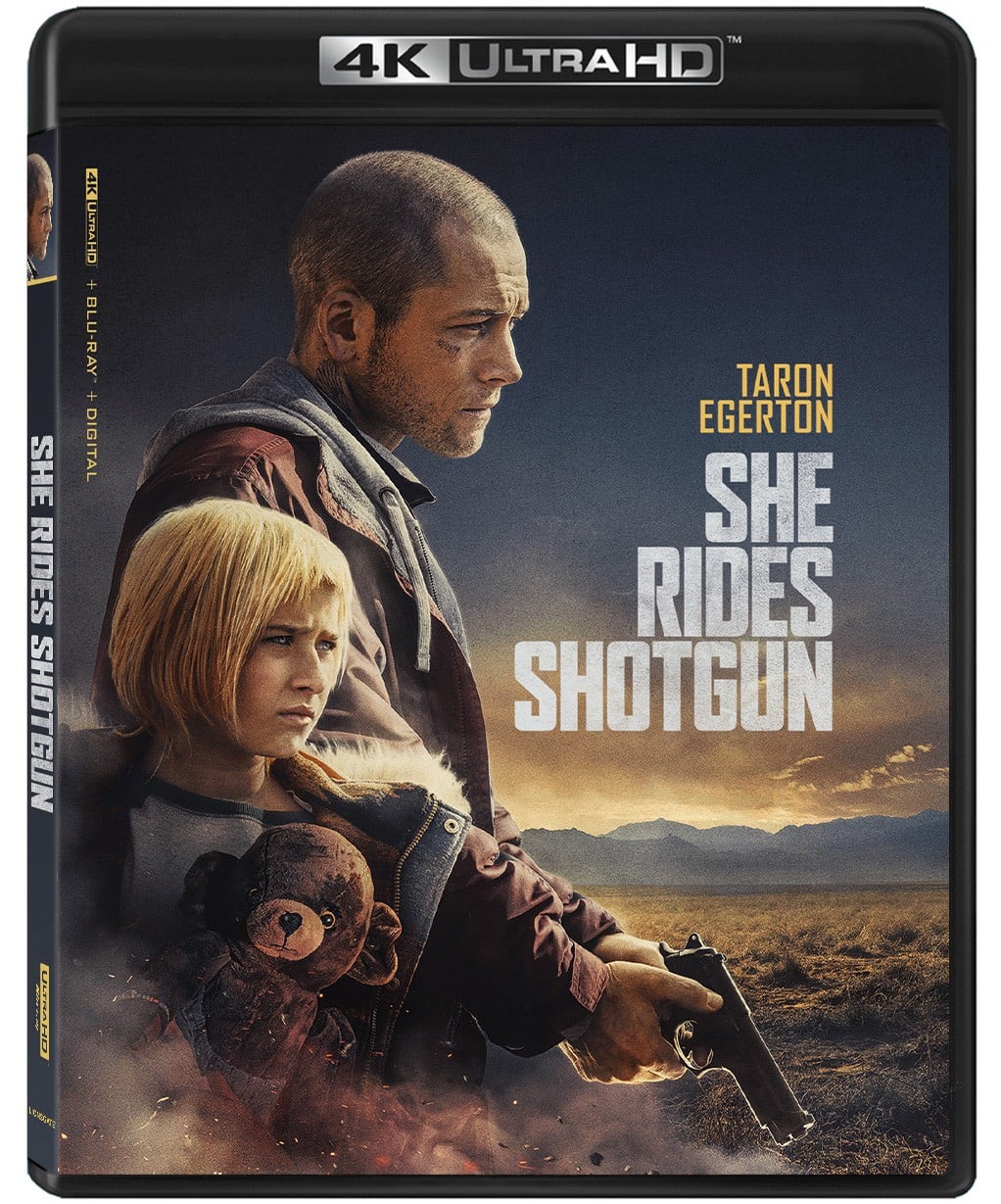 A man holding a gun stands protectively with a young girl in front of him; “She Rides Shotgun” title and “Taron Egerton” name appear on the 4K Ultra HD movie cover.