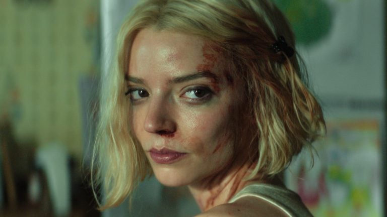 ‘Lucky’ Season 1 Review: Anya Taylor-Joy Shines In A Slick, Propulsive Crime Caper A woman with short blonde hair and visible bruises on her face looks over her shoulder with a serious expression.