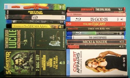 No Streaming Required: Physical Media Spotlight For The Week Of June 30th A collection of DVD and Blu-ray cases, including films, TV series, and box sets, arranged in two stacks on a flat surface.