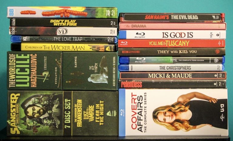 No Streaming Required: Physical Media Spotlight For The Week Of June 30th A collection of DVD and Blu-ray cases, including films, TV series, and box sets, arranged in two stacks on a flat surface.