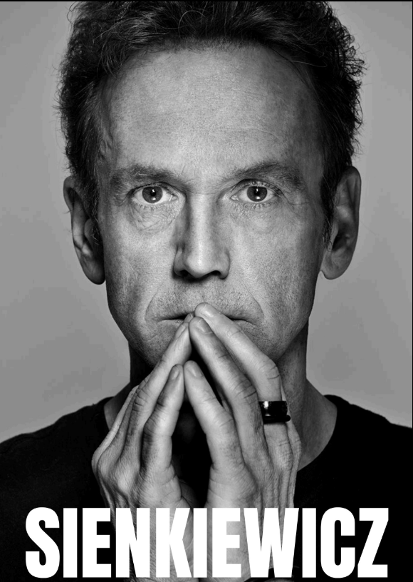 Black-and-white portrait of a man with hands touching his face, wearing a dark shirt and ring, with the word "SIENKIEWICZ" in bold white letters at the bottom.