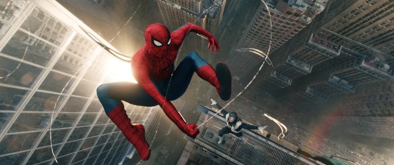 Spider-Man: Brand New Day Comparison Shows How Insomniac’s Games Influenced The Movie Spider-Man swings through a city with tall buildings, while another costumed figure follows behind, both high above the street below.