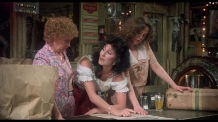 ‘Come Back To The 5 & Dime, Jimmy Dean, Jimmy Dean’ 4K UHD Blu-Ray Review – An Overlooked Robert Altman Gem Three women stand around a counter in a vintage-style store, looking down at a newspaper spread out before them.