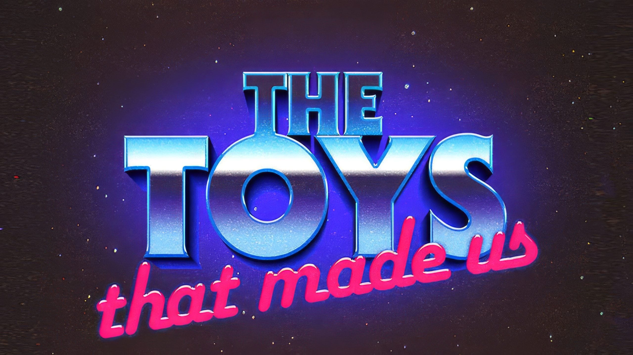 The image shows the title "The Toys That Made Us" in bold, shiny letters with a blue and pink retro style against a dark, starry background.
