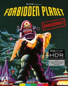 A large robot holds an unconscious woman in a futuristic landscape, with bold text reading “Forbidden Planet” and “Amazing!” above.