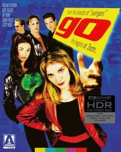 Five young adults pose against a colorful, graphic background with the film title “go” and tagline “life begins at 3 a.m.” displayed prominently.