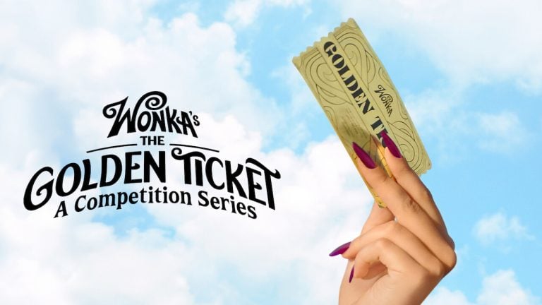 Wonka’s The Golden Ticket Review – A Stunning Cutthroat Reality Series The Golden Ticket A hand with purple nails holds a golden ticket against a blue sky. Text reads, “Wonka’s The Golden Ticket: A Competition Series.”.