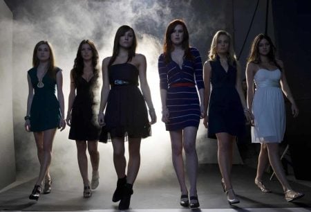 Lionsgate To Release The Horror Remake ‘Sorority Row’ On 4K UHD Blu-Ray This September Six young women walk confidently toward the camera in a smoky, dimly lit room, all wearing dresses and heels.