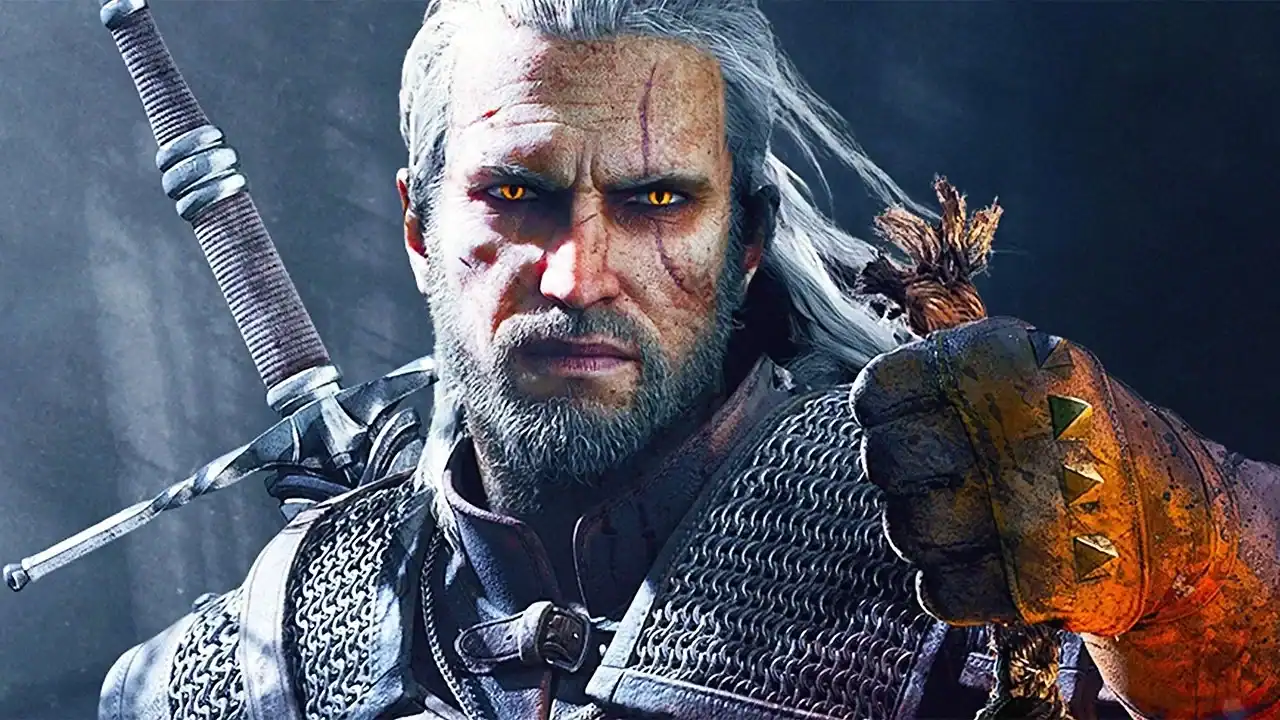 The Witcher Star Wants AI Platforms Using His Voice “Sued Into The Ground” A white-haired, armored man with yellow eyes holds a monster trophy. A sword is strapped to his back. The background is dark and misty.