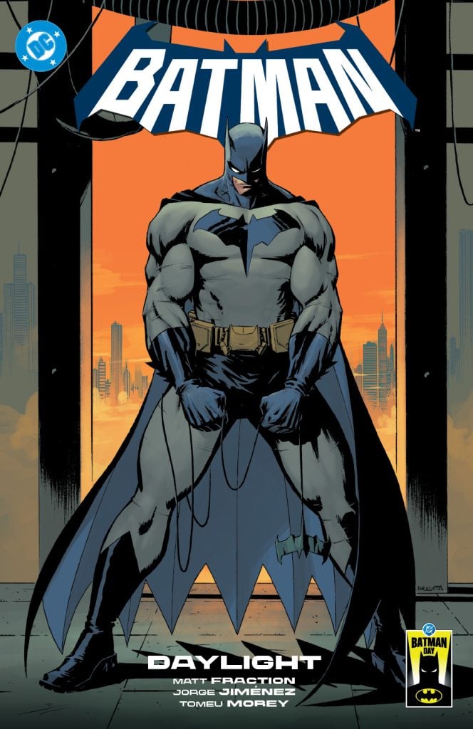 Batman stands in front of a cityscape at sunset, wearing his grey and black suit with a cape, on the cover of a comic titled “Daylight.”.