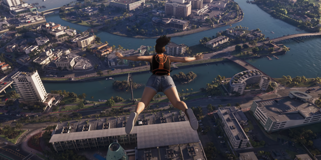 A person with a backpack skydives over a city with rivers, bridges, and tall buildings visible below.