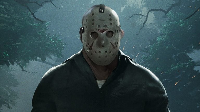 A person wearing a hockey mask and dark clothing stands in a misty forest with trees in the background.