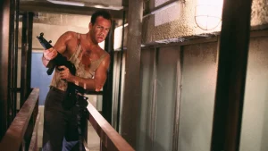 20th Century Studios To Release The Original ‘Die Hard’ Trilogy On 4K UHD Blu-Ray This December A man in a bloodstained tank top holds a submachine gun while standing in a narrow corridor.