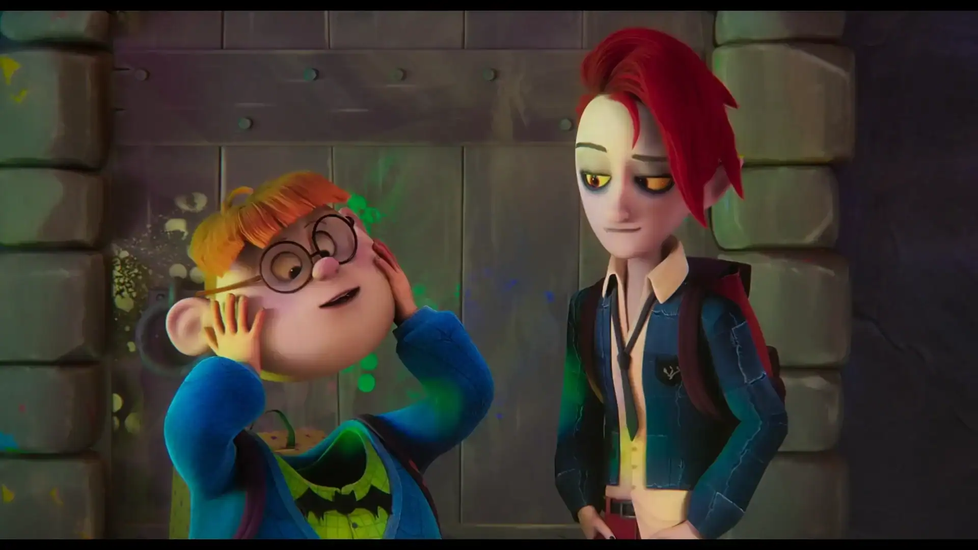 Two animated characters standing in front of a stone wall; one has red hair and glasses, while the other has tall, spiked red hair.