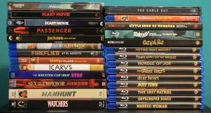 Two stacks of Blu-ray and 4K Ultra HD movie cases on a shelf.