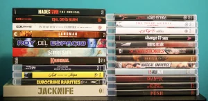 Two stacks of Blu-ray and 4K film cases arranged on a surface against a blue background.
