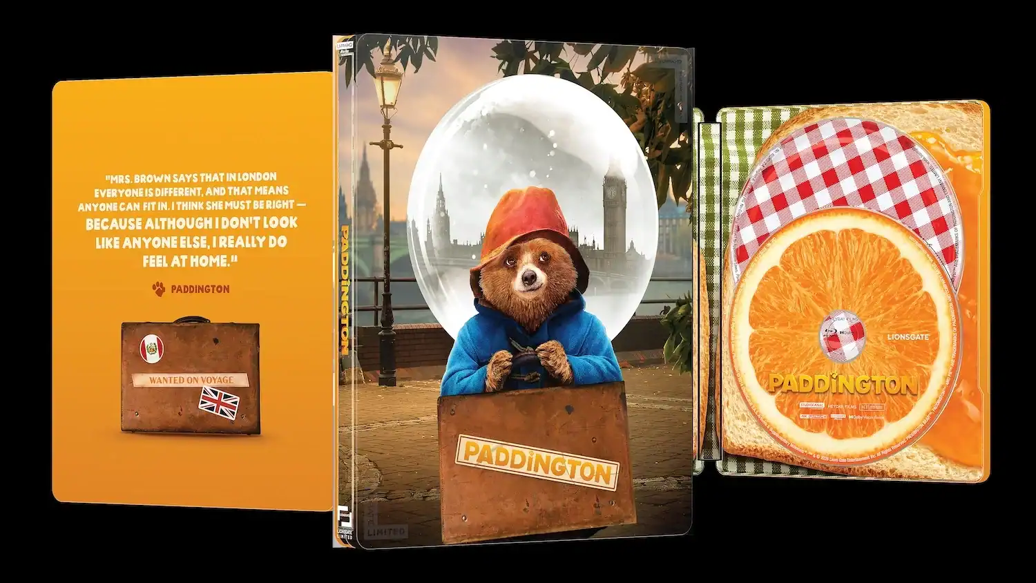 Paddington Blu-ray steelbook case featuring a snow globe image of Paddington, a quote about feeling at home, and a disc designed to look like a slice of toast with orange marmalade.