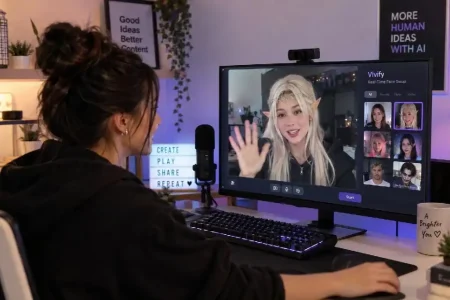 A person at a computer uses Vivify software to apply a digital elf filter to their video call.