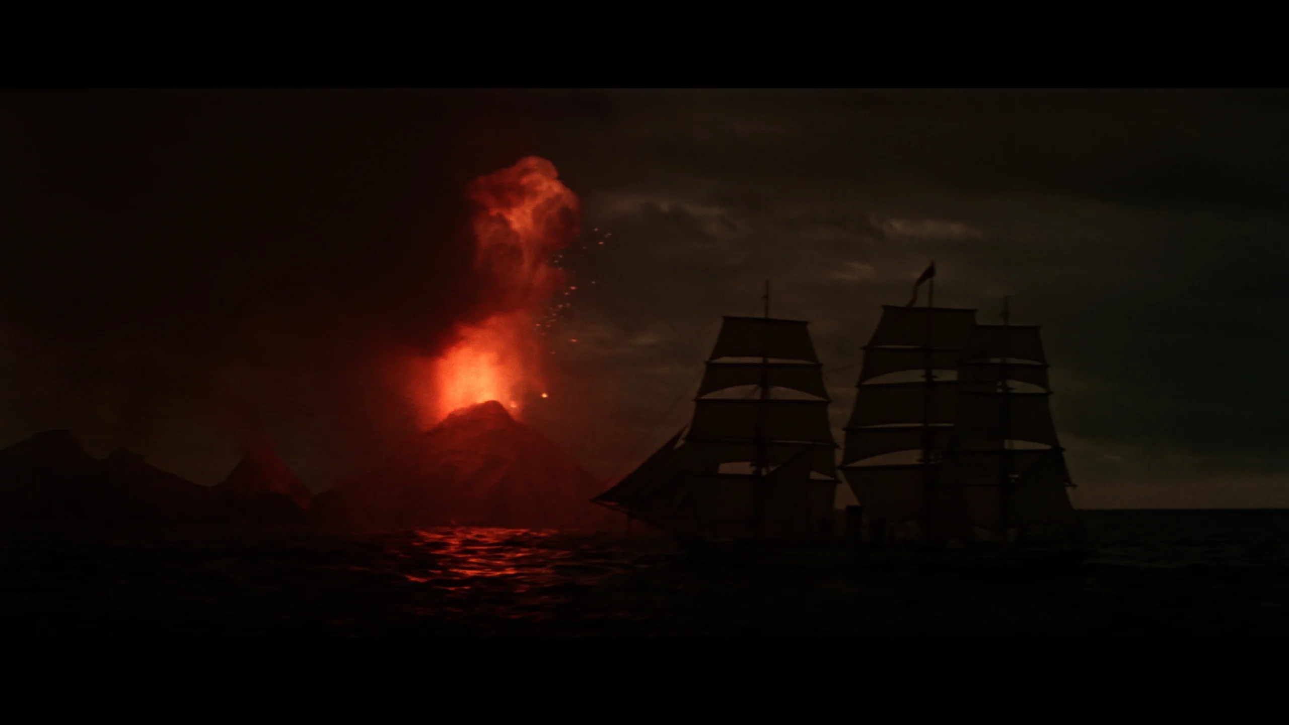 A tall ship sailing on the ocean at night near an erupting volcano.